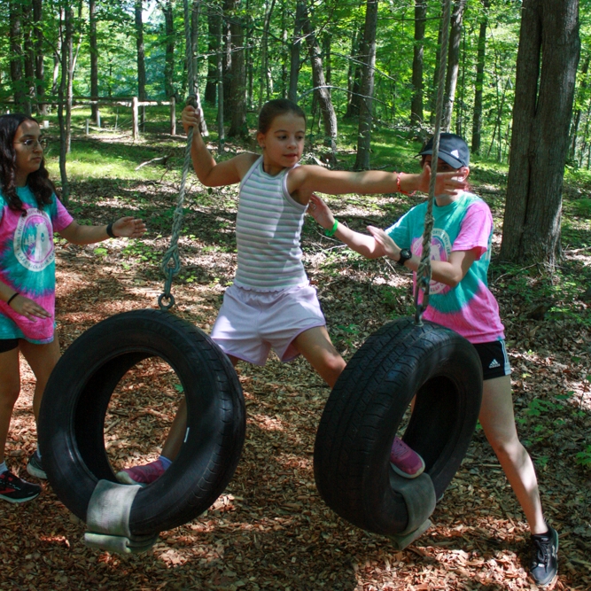 three girls roasting marshmallows 