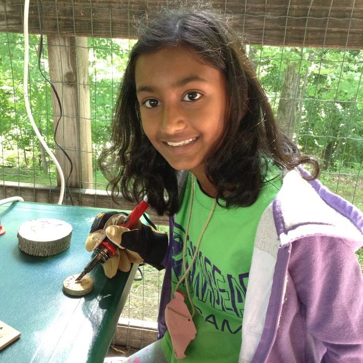 three girls roasting marshmallows 