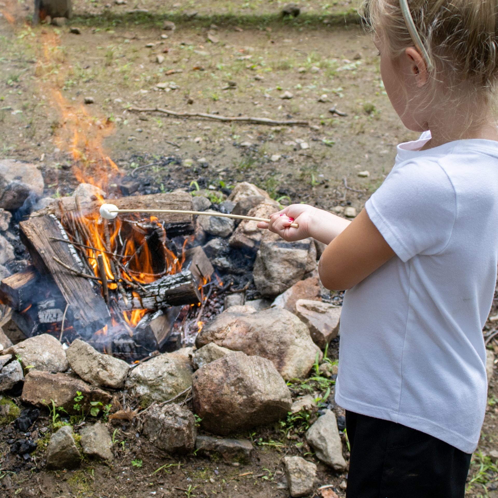 three girls roasting marshmallows 